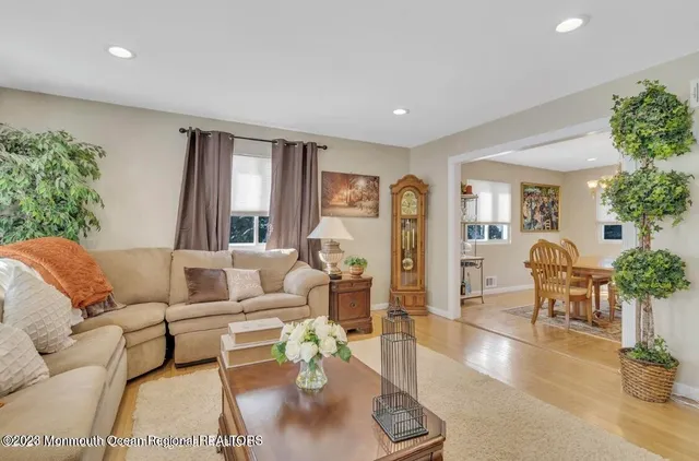 a living room with furniture and potted plants