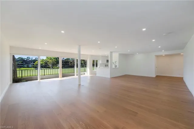 a view of a room with wooden floor and fence