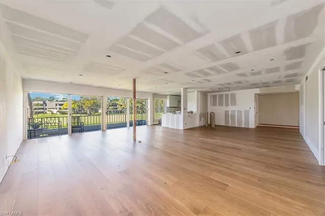 a view of room with wooden floor and glass door