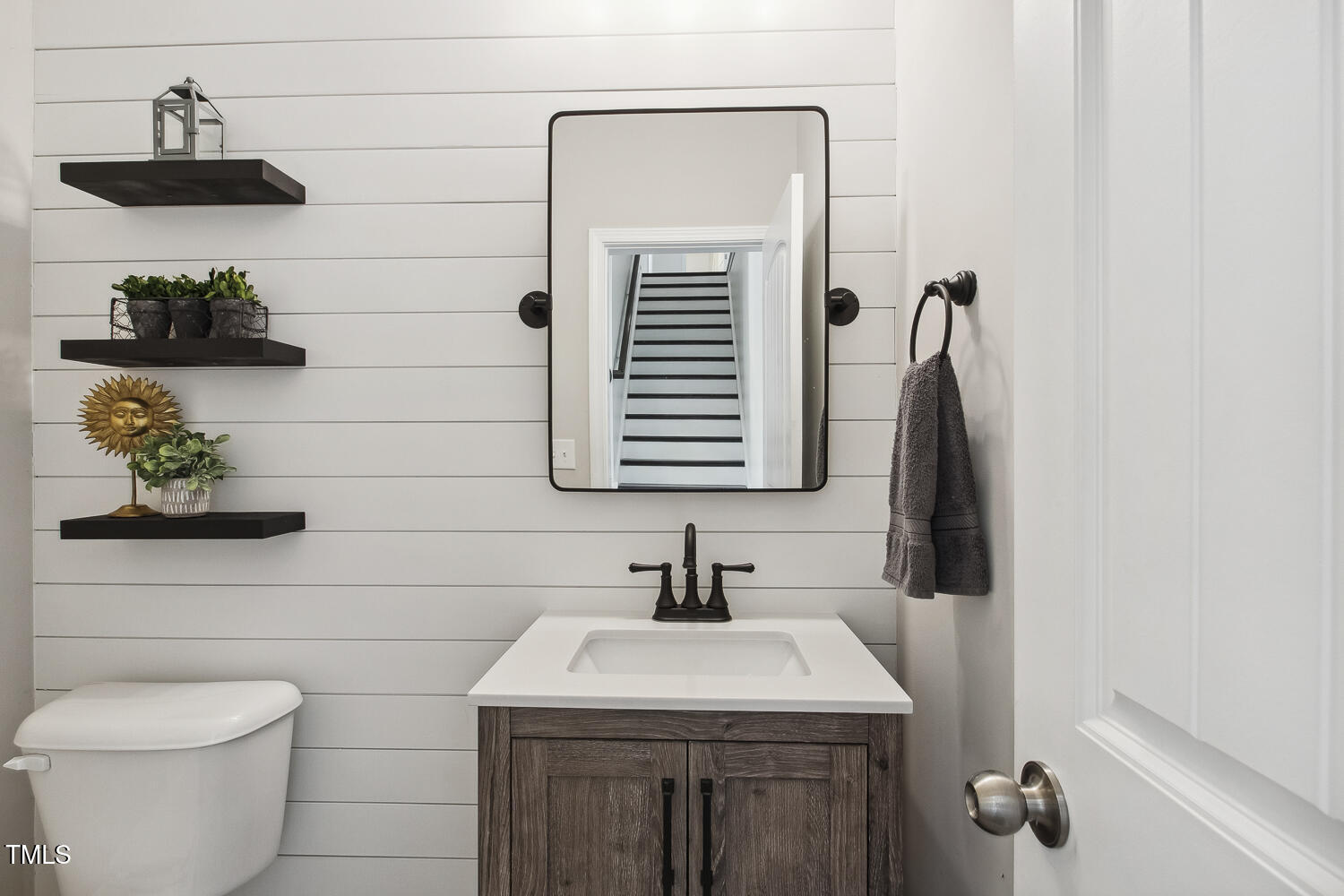 192 Springhill Lane Garner, NC 27529 - Photo 24 of 43 Cute powder room has shiplap and custom tiled floor.
