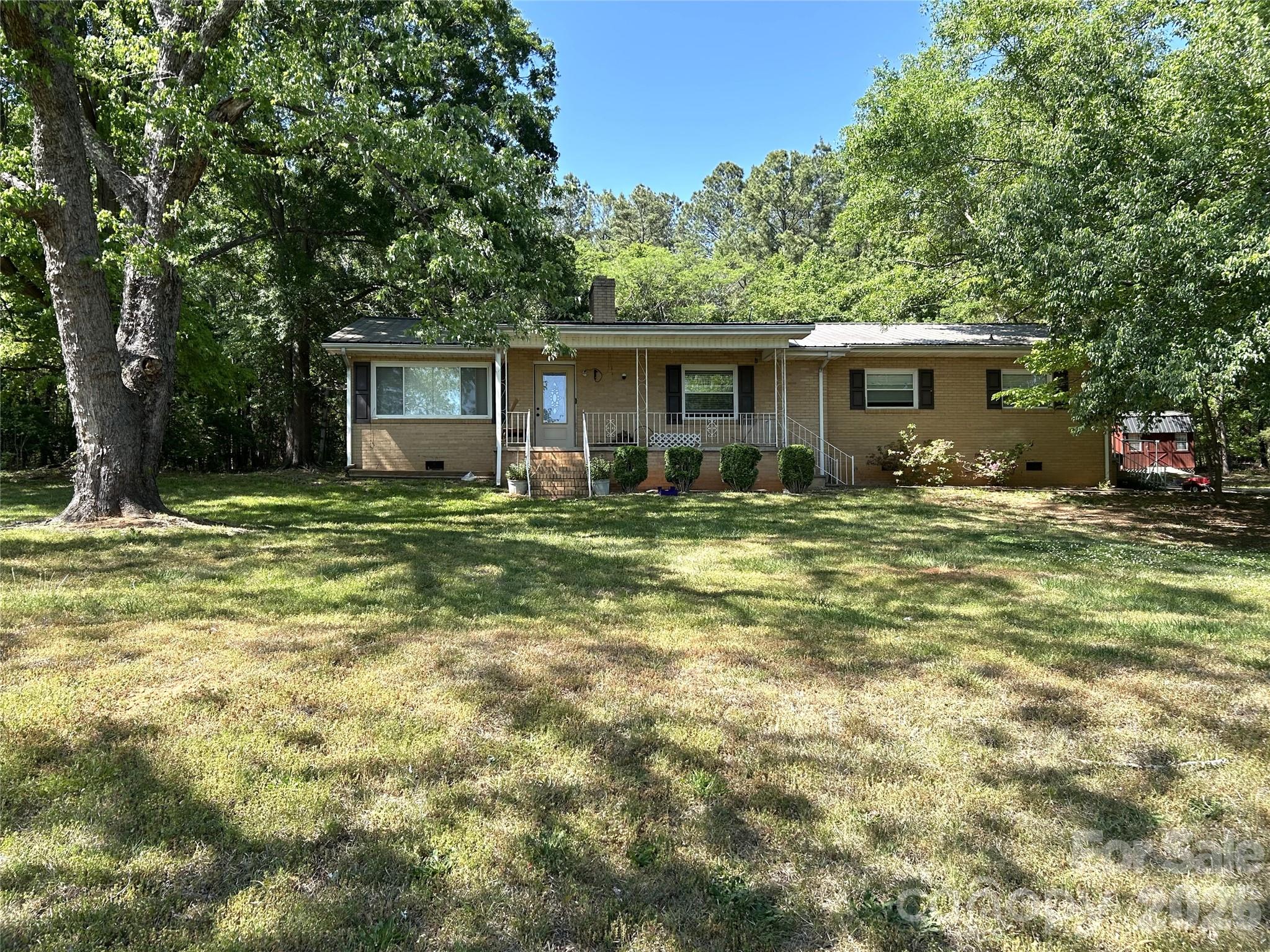 2307 Harris Henrietta Road Forest City, NC 28043 - Photo 4 of 31 a house view with a sitting space and garden