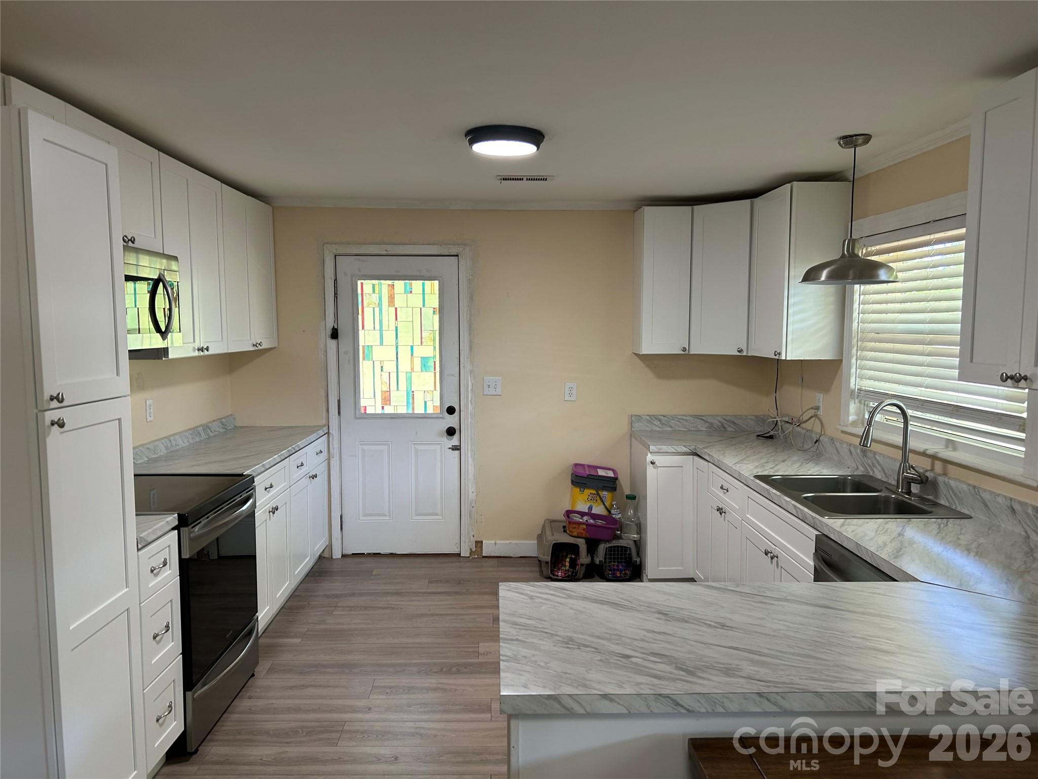 2307 Harris Henrietta Road Forest City, NC 28043 - Photo 10 of 31 a kitchen with granite countertop a stove and a sink