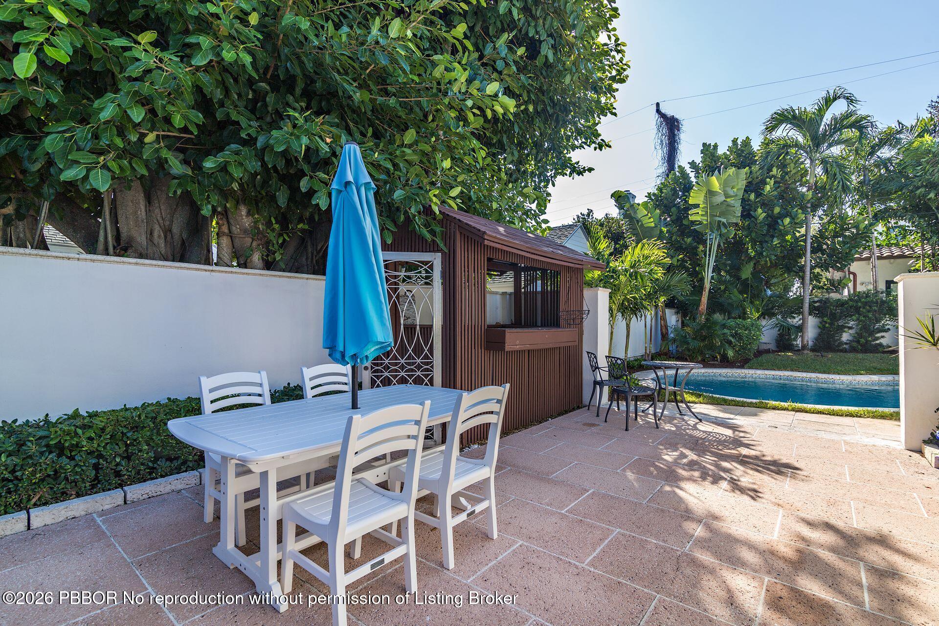 224 Churchill Road West Palm Beach, FL 33405 - Photo 24 of 33 a view of a patio with table and chairs and potted plants with wooden floor and fence