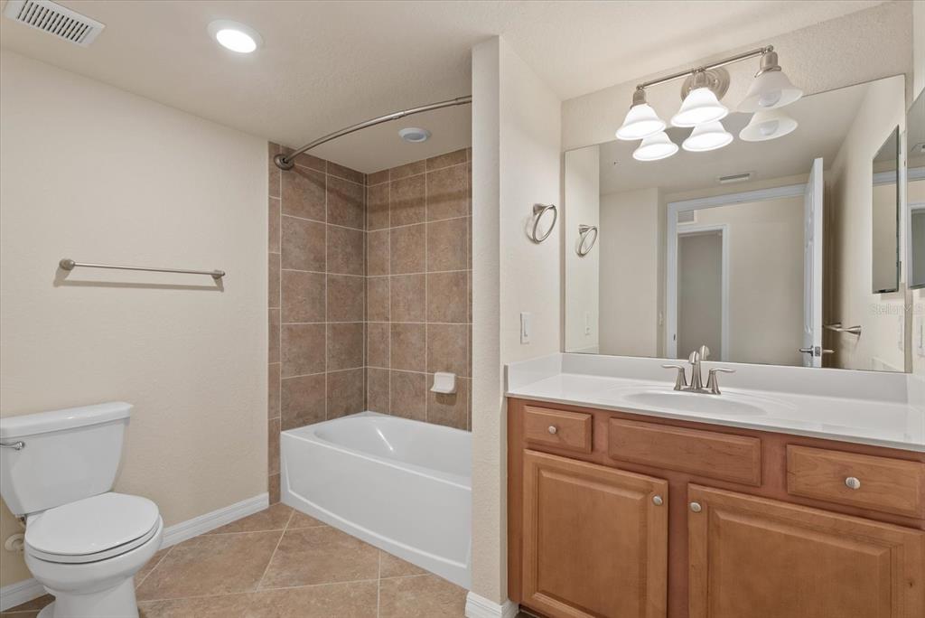 20080 Ragazza Circle, Unit 102 Venice, FL 34293 - Photo 29 of 49 a bathroom with a sink a toilet and a bathtub