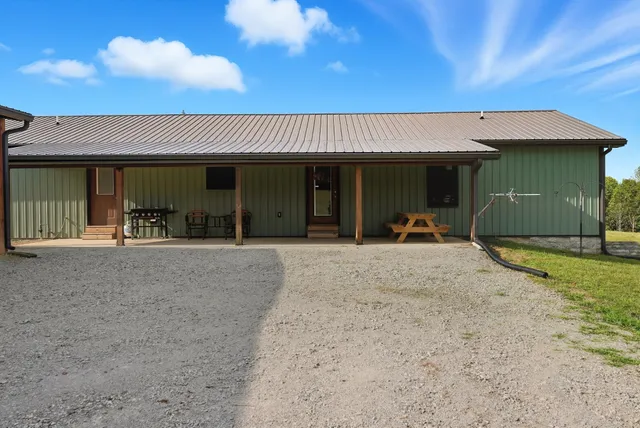 a dining room with furniture a rug and kitchen view