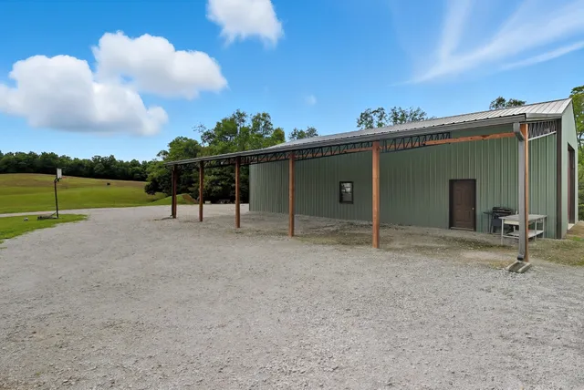 a living room with furniture a flat screen tv and a large window