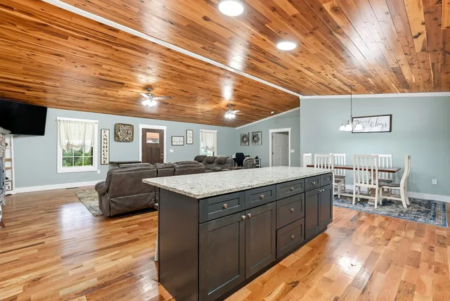 a bathroom with a granite countertop sink a toilet and a mirror