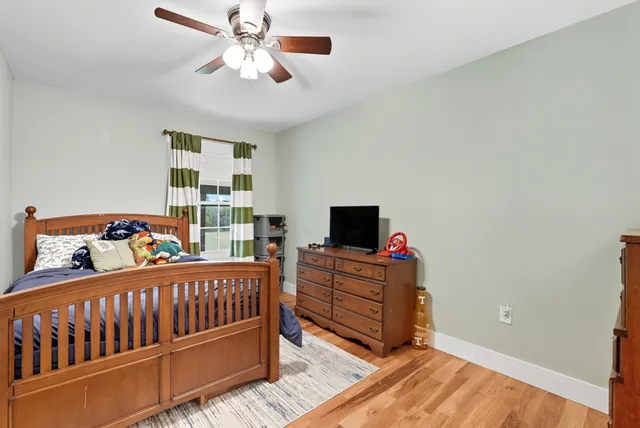 a spacious bathroom with a granite countertop sink and a mirror