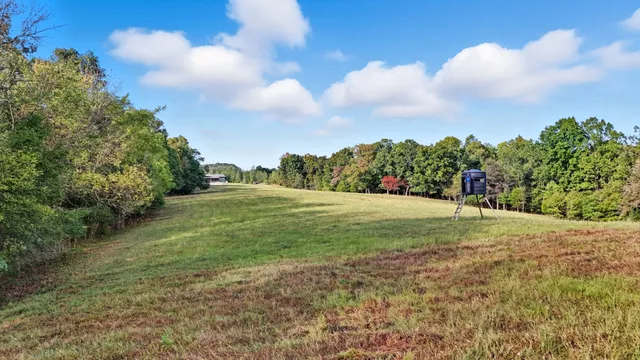 a view of an house with porch and a yard