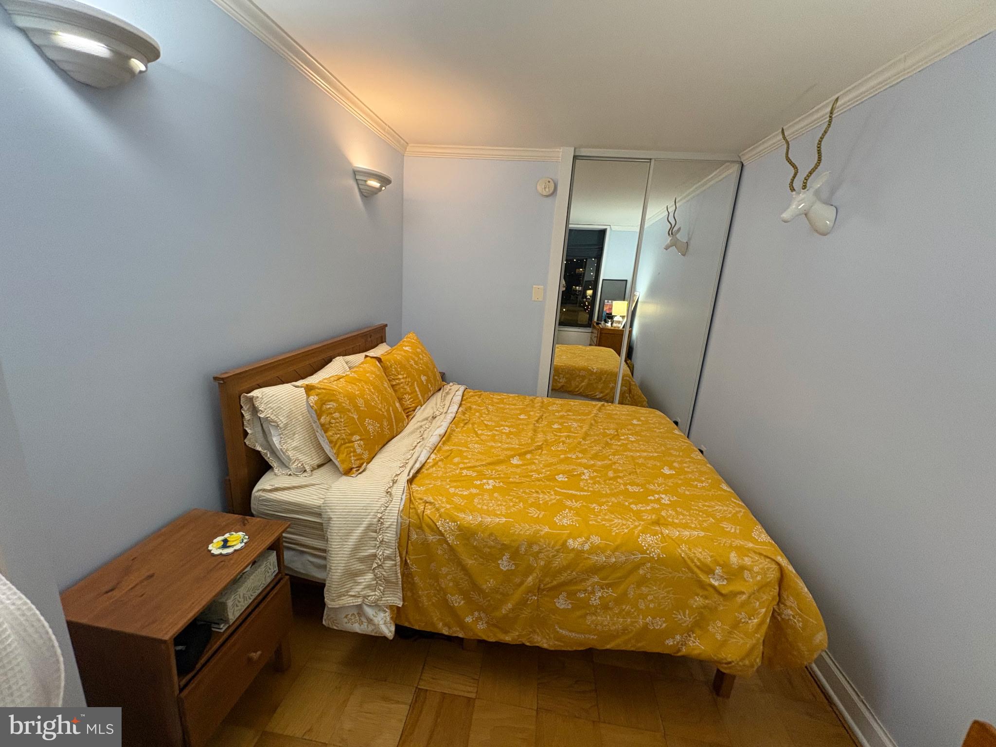 490 M Street Southwest, Unit W608 Washington, DC 20024 - Photo 7 of 12 a bed sitting in a bedroom next to a window