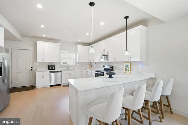 a kitchen with white cabinets and white appliances