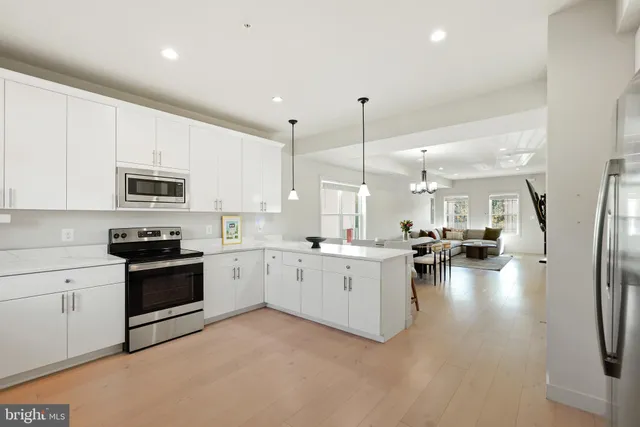 a kitchen with sink cabinets and wooden floor