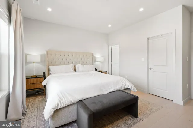 a bedroom with a bed and a night stand