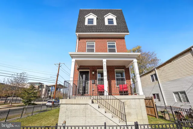 a view of a white house with large windows