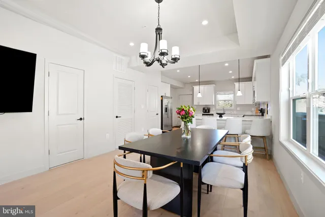 a view of a dining room with furniture and a chandelier