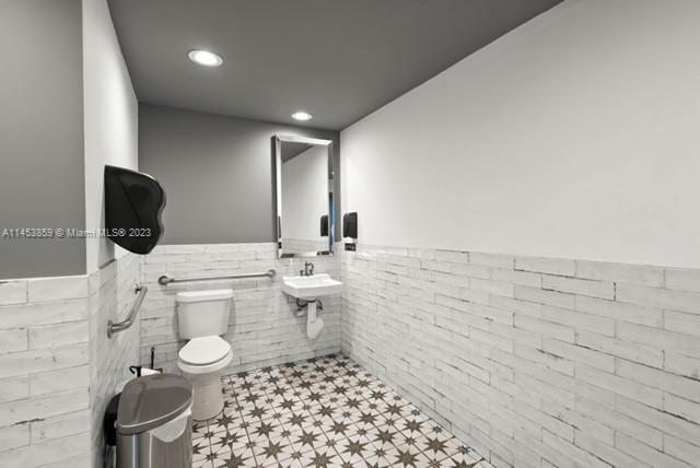 8th Street Miami, FL 33130 - Photo 23 of 38 a bathroom with a sink a toilet and mirror