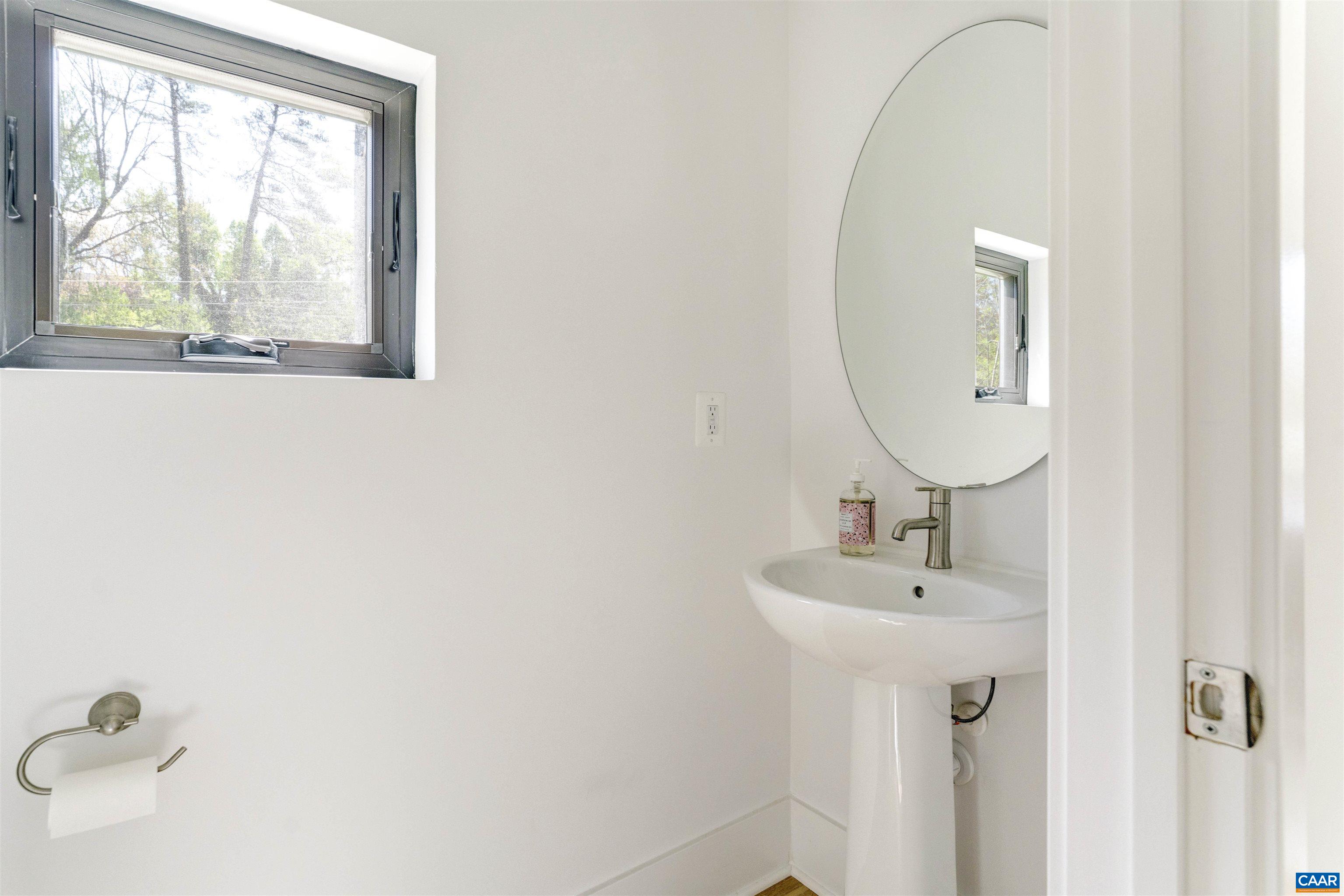 987 5th Street Southwest Charlottesville, VA 22903 - Photo 16 of 33 a bathroom with a sink and a mirror