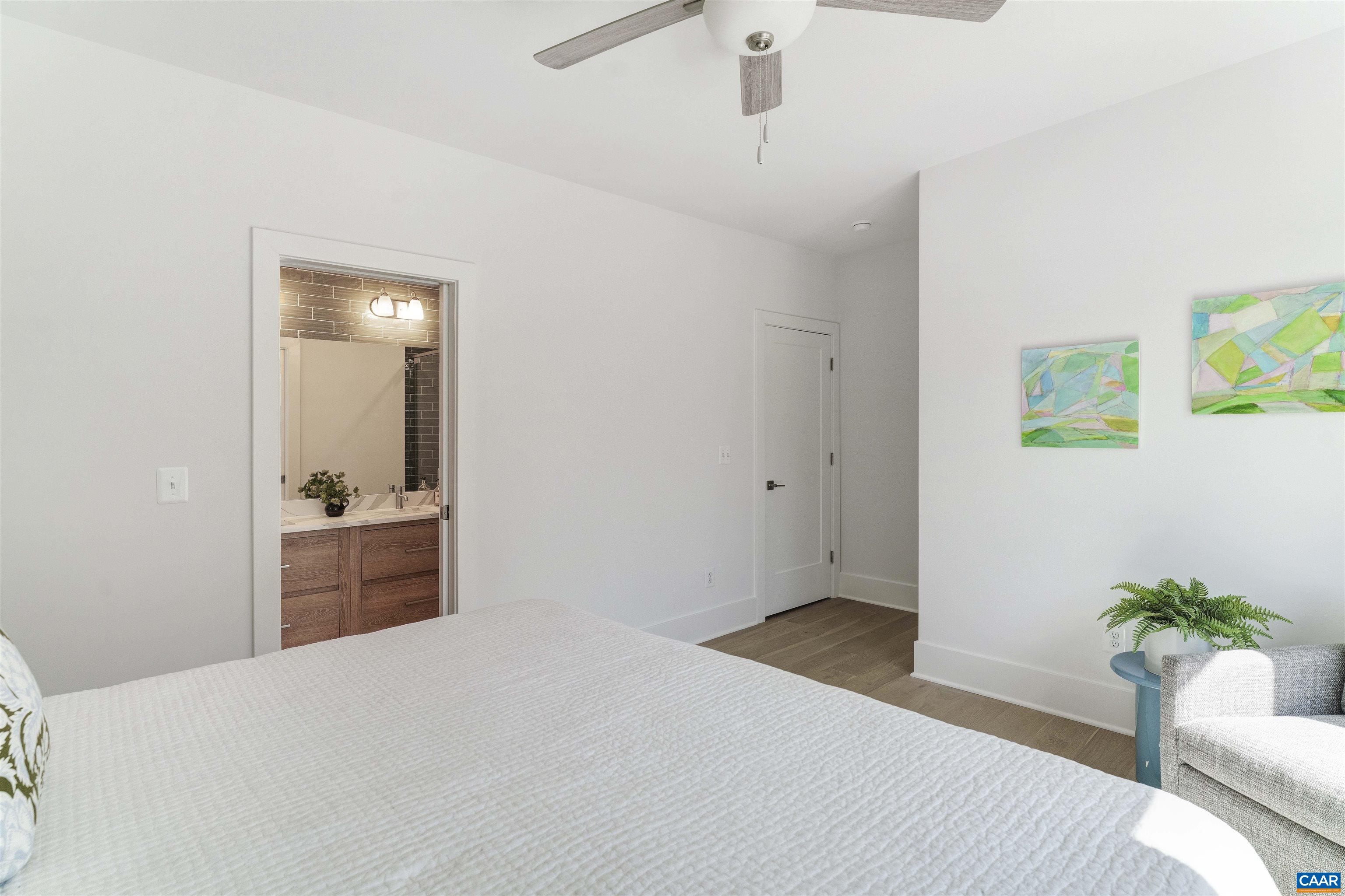 987 5th Street Southwest Charlottesville, VA 22903 - Photo 19 of 33 a bedroom with a bed and a potted plant