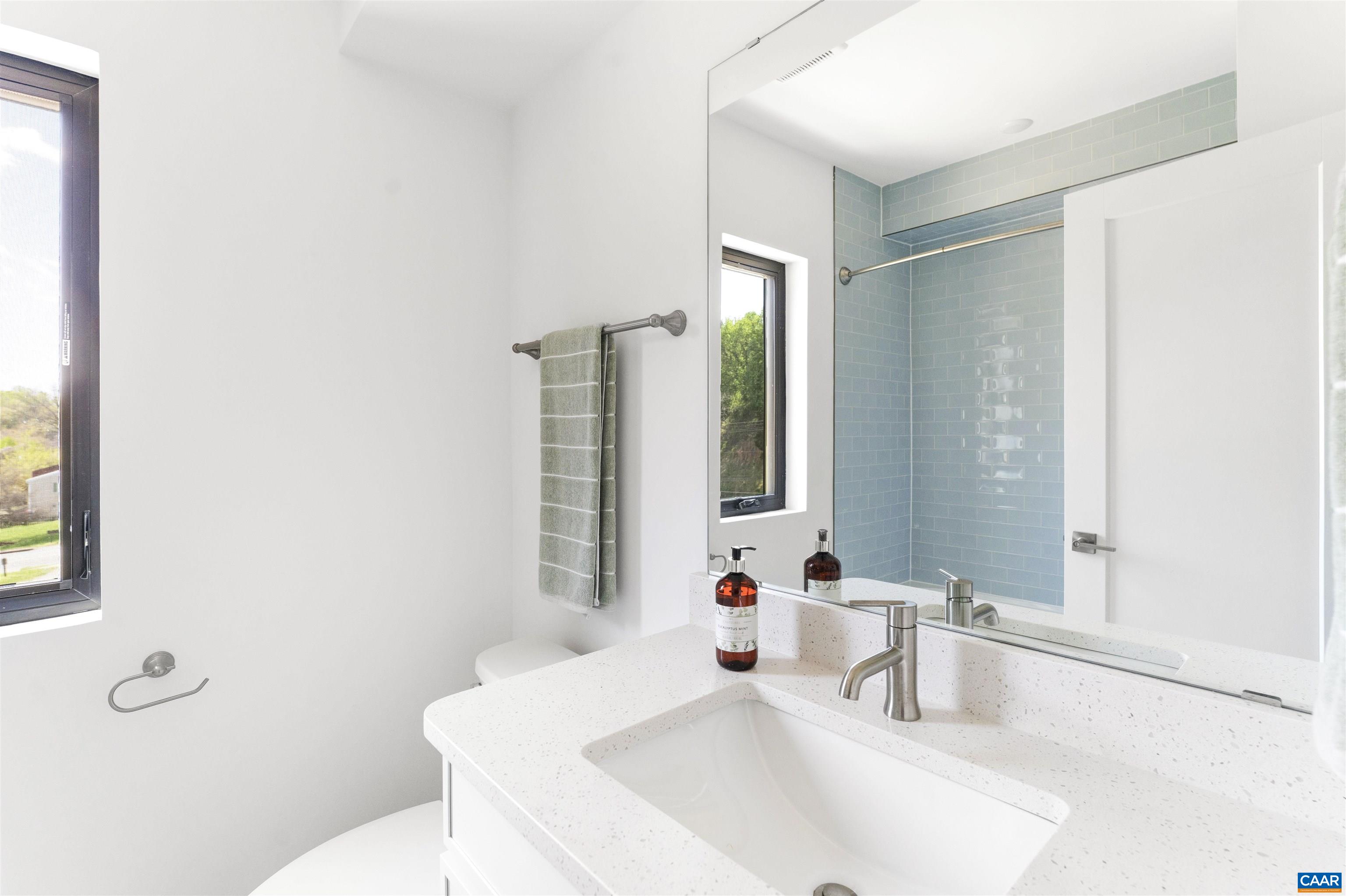 987 5th Street Southwest Charlottesville, VA 22903 - Photo 26 of 33 a bathroom with a sink and a large mirror