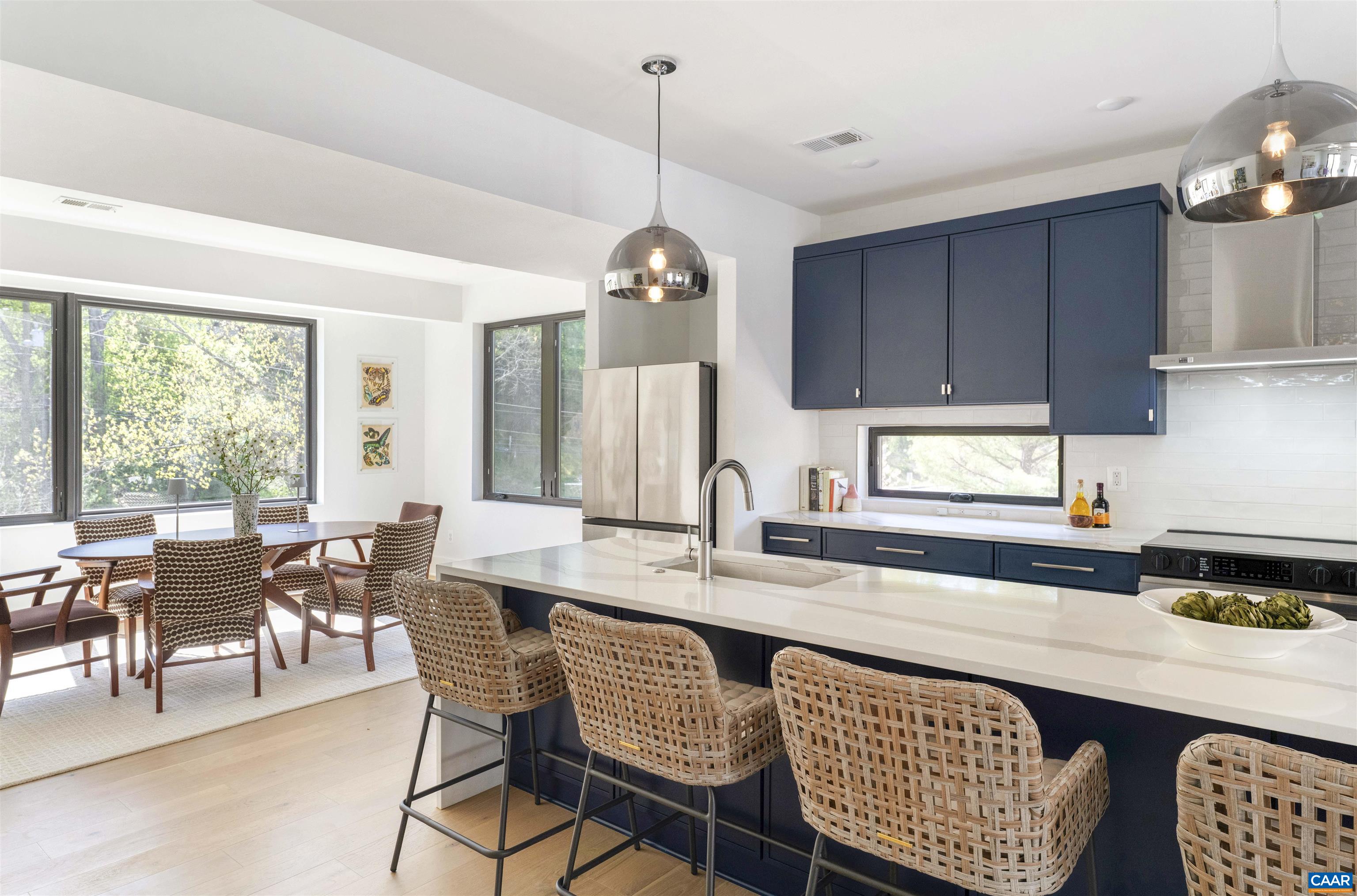 987 5th Street Southwest Charlottesville, VA 22903 - Photo 6 of 33 a kitchen with a dining table chairs and large windows