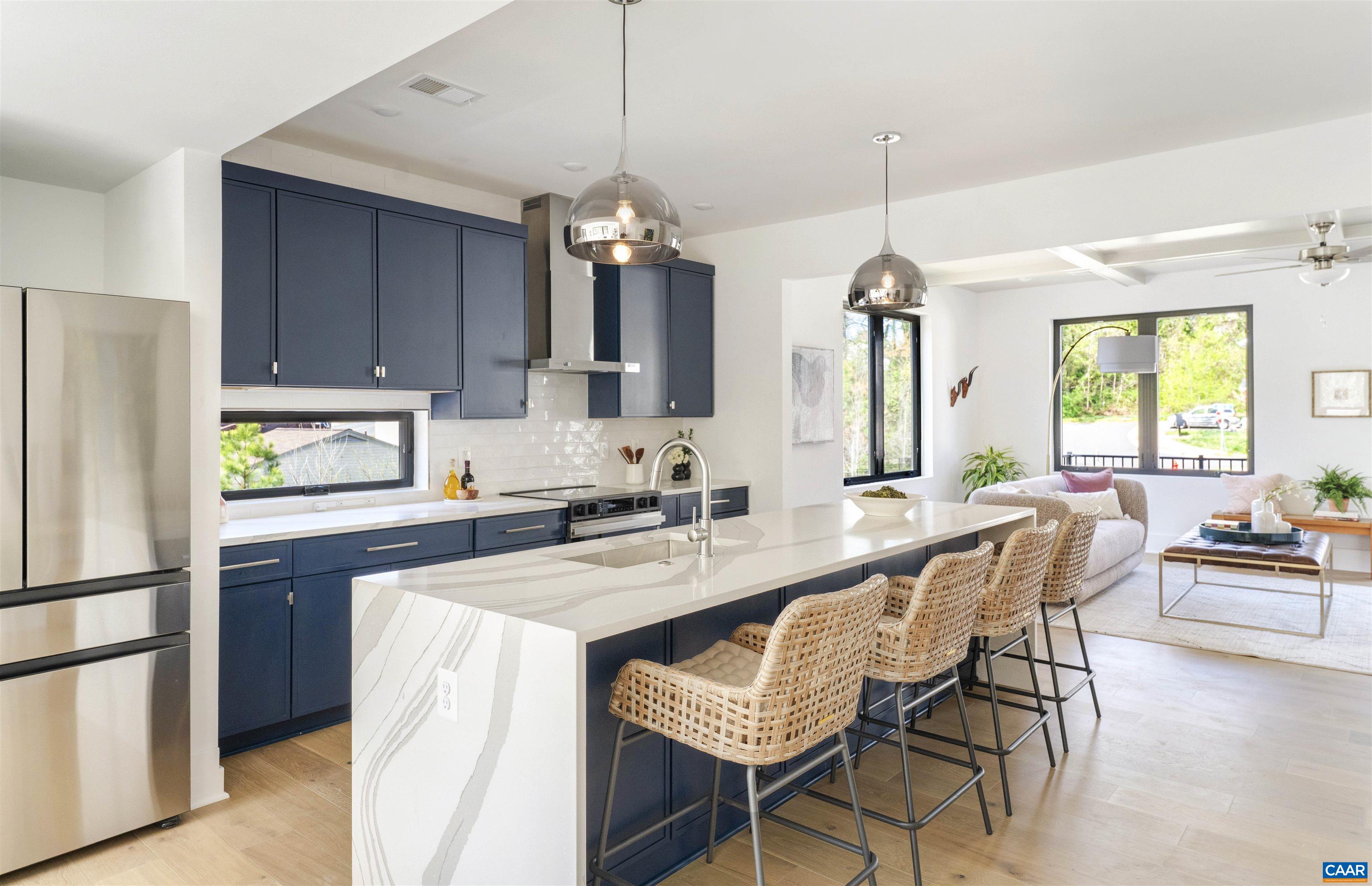 987 5th Street Southwest Charlottesville, VA 22903 - Photo 9 of 33 a kitchen with granite countertop a sink a center island and stainless steel appliances