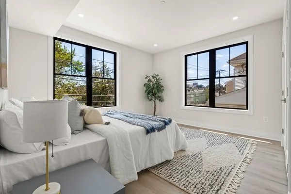 a bedroom with furniture and a window