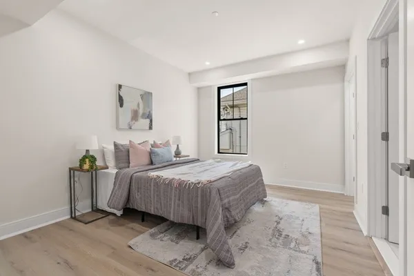 a bedroom with a bed and a painting