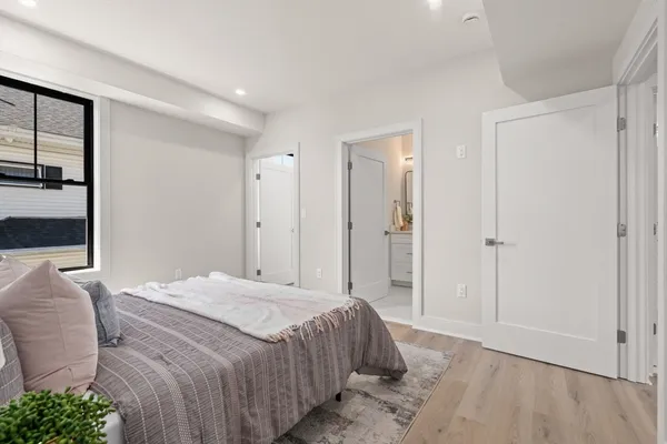 a bedroom with a bed and hallway