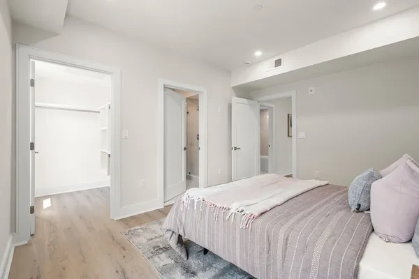 a bedroom with a bed and hallway