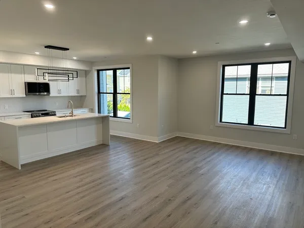 a large white kitchen with a large window