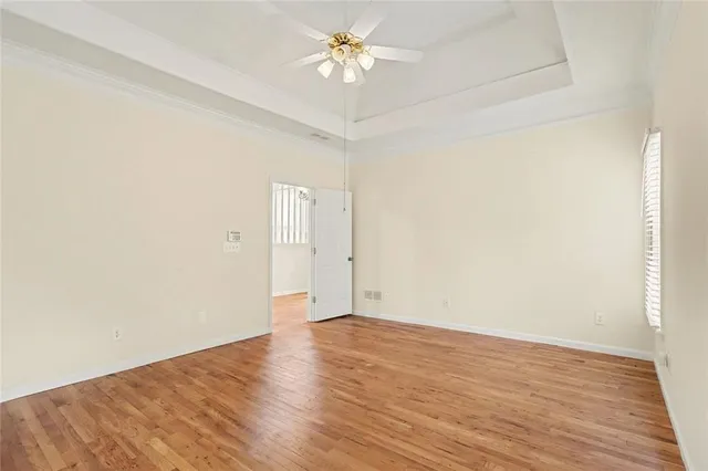 a view of an empty room with wooden floor