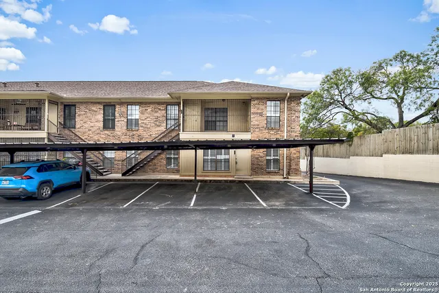 a view of a house with backyard and sitting area