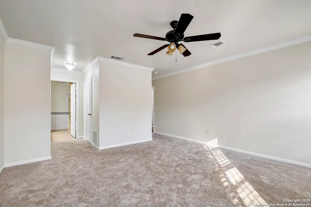 a view of a big room with closet and a ceiling fan