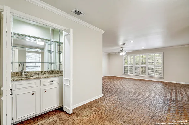 a bathroom with a granite countertop sink a large mirror and a bathtub next to a window