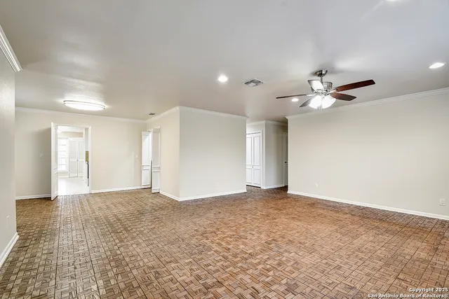 a view of an empty room with a ceiling fan
