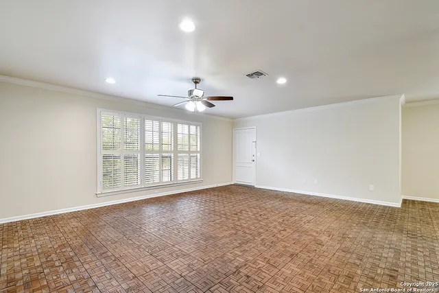 a view of an empty room with a window