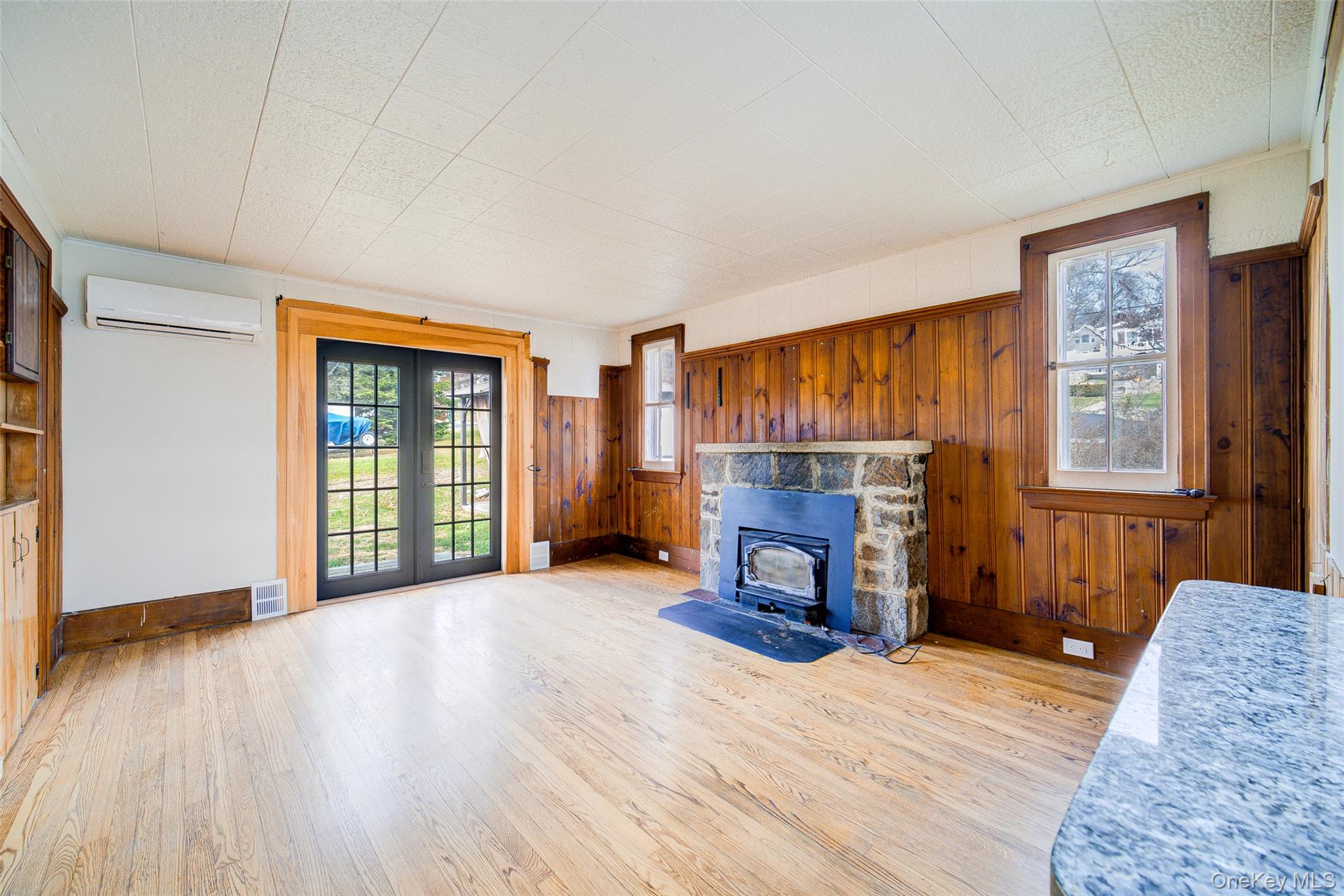 17 Baldwin Road Carmel, NY 10512 - Photo 3 of 29 an empty room with windows fireplace and wooden floor