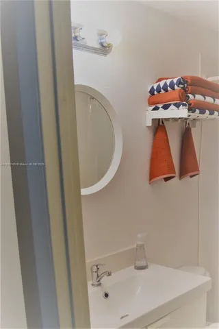 a bathroom with a sink and mirror