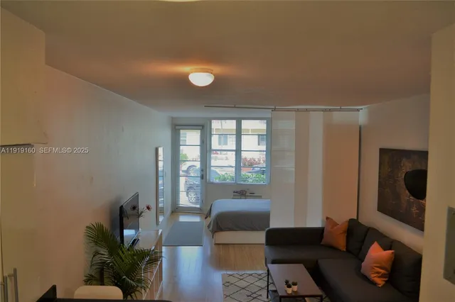 a living room with furniture and a floor to ceiling window