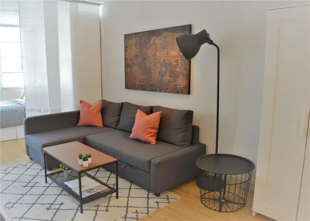 a living room with furniture and a painting