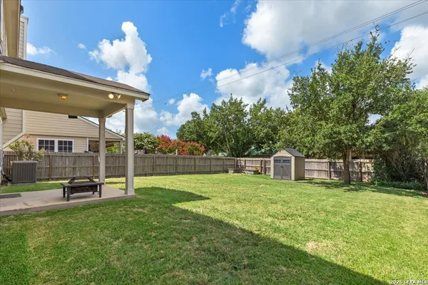 a view of a house with a backyard and a patio