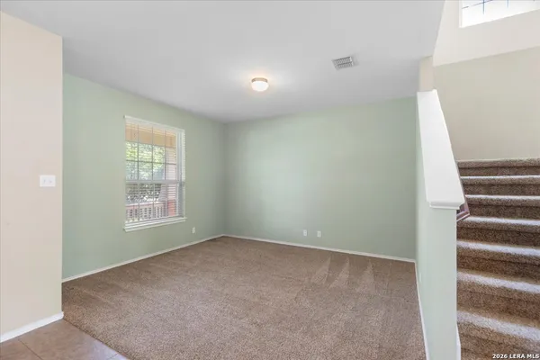 a view of an empty room with a window