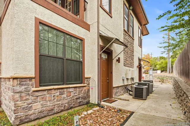 a view of a brick house with many windows