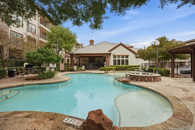 swimming pool view with a seating space and a garden view