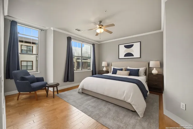 a bedroom with a bed and wooden floor