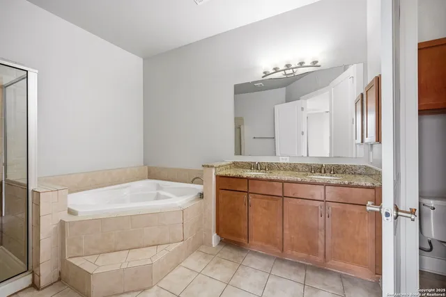 a bathroom with a tub sink and mirror