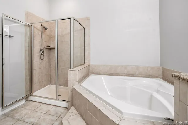 a bathroom with a bathtub and shower