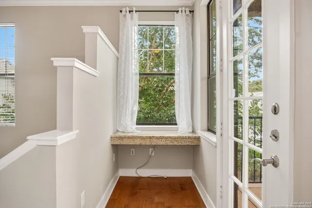 a white bath tub sitting in a bathroom next to a window