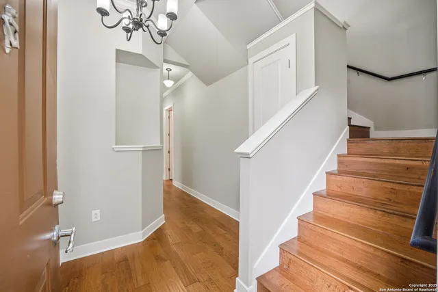 a view of entryway and hall with wooden floor