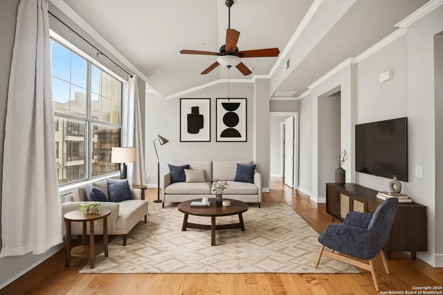 a living room with furniture a rug and a flat screen tv